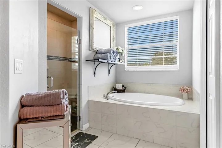 Bathroom featuring plus walk in shower