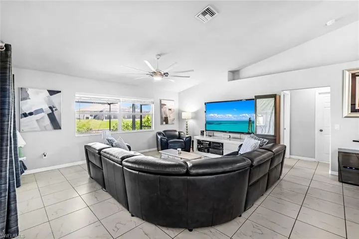 Living room featuring lofted ceiling and ceiling fan