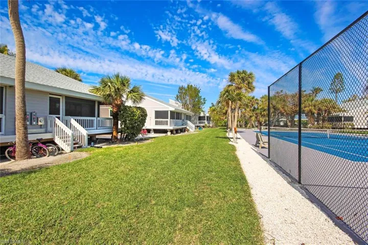 View of yard and tennis court
