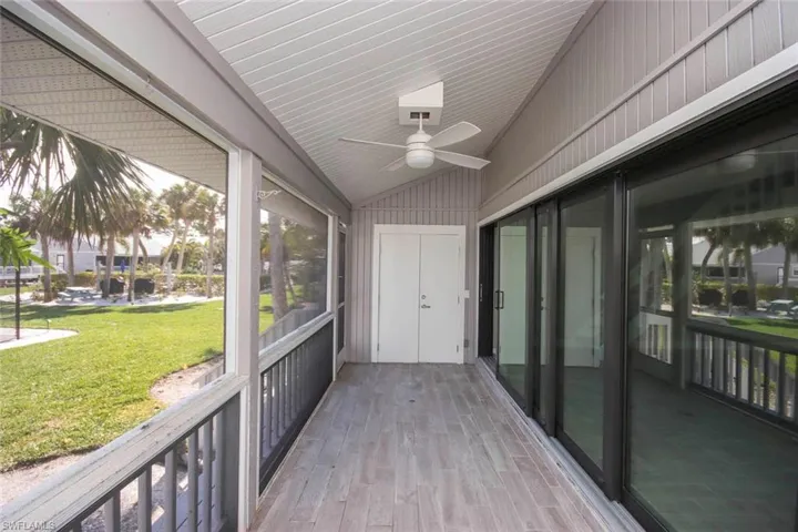 Sunroom featuring ceiling fan and vaulted ceiling