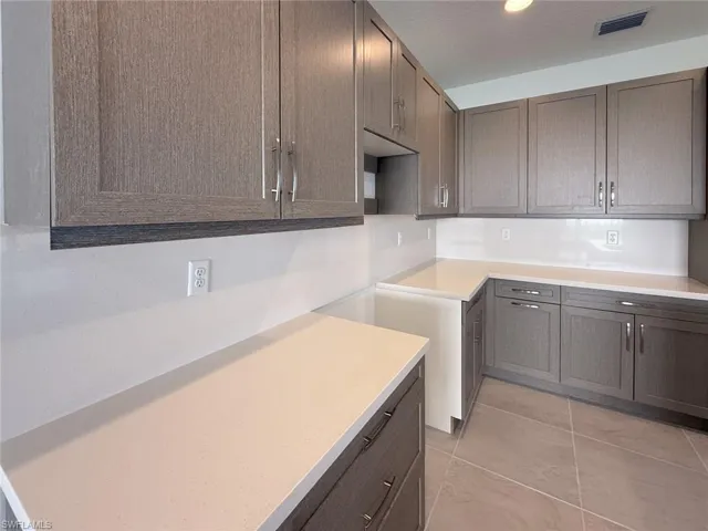 Kitchen featuring light tile patterned floors and a textured ceiling