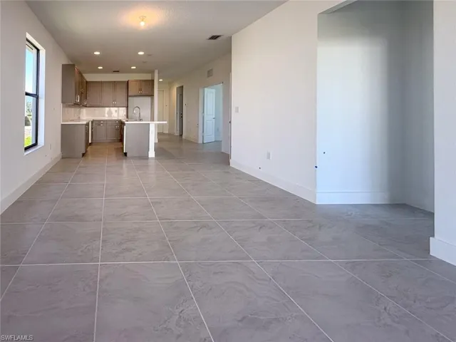 Unfurnished living room with sink