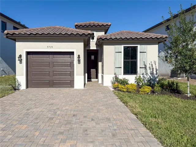 Mediterranean / spanish-style house with a garage