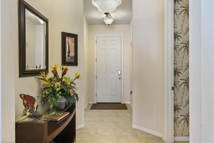 Entryway featuring baseboards and tile patterned floors