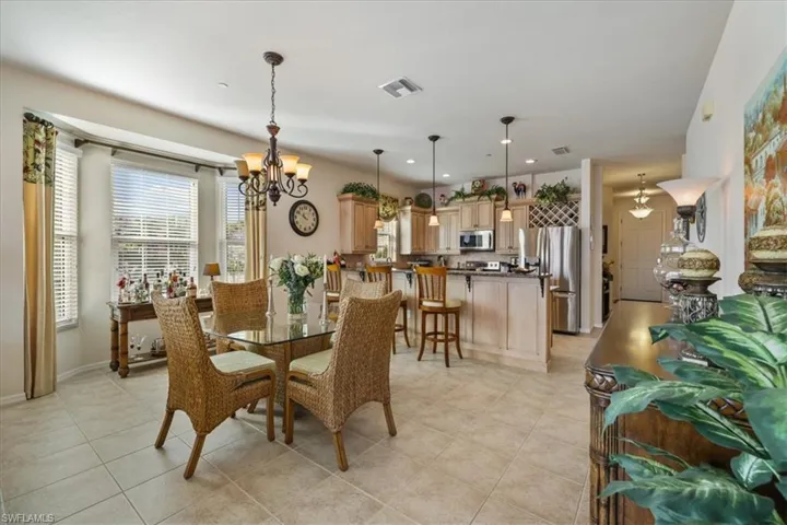Dining room featuring a chandelier, recessed lighting, and light tile patterned floors