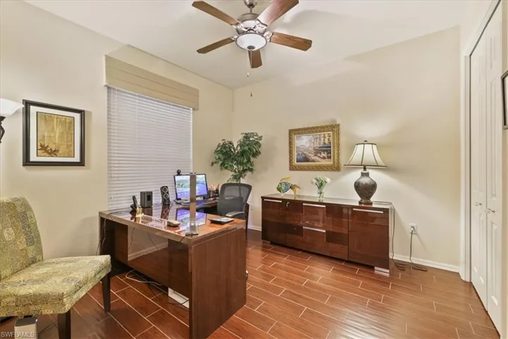 Office space featuring wood tiled floors and ceiling fan