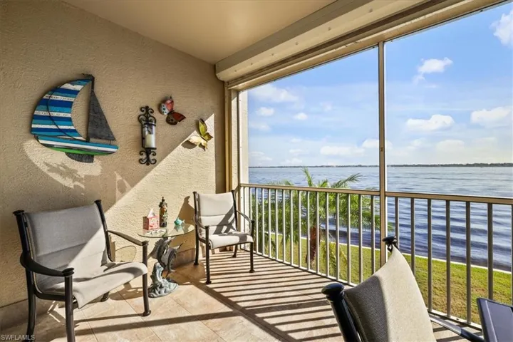 Balcony with a sunroom and a water view