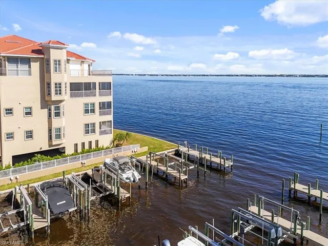 Dock area with boat lift and a water view