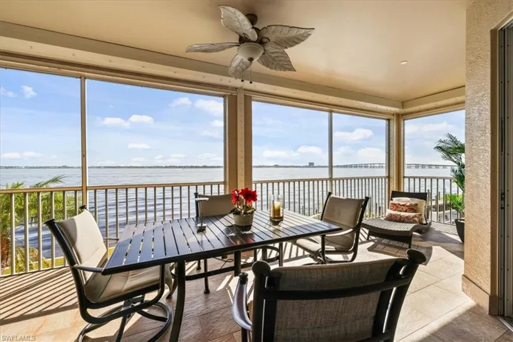 Sunroom featuring a water view and tile patterned floors