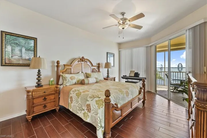Bedroom featuring wood tiled floors, access to exterior, and a ceiling fan