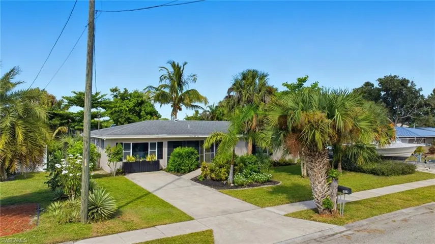 View of front of home with a front lawn and concrete driveway
