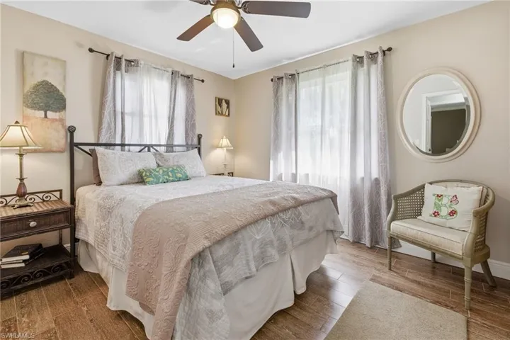 Bedroom featuring wood tile floors, a closet, and ceiling fan