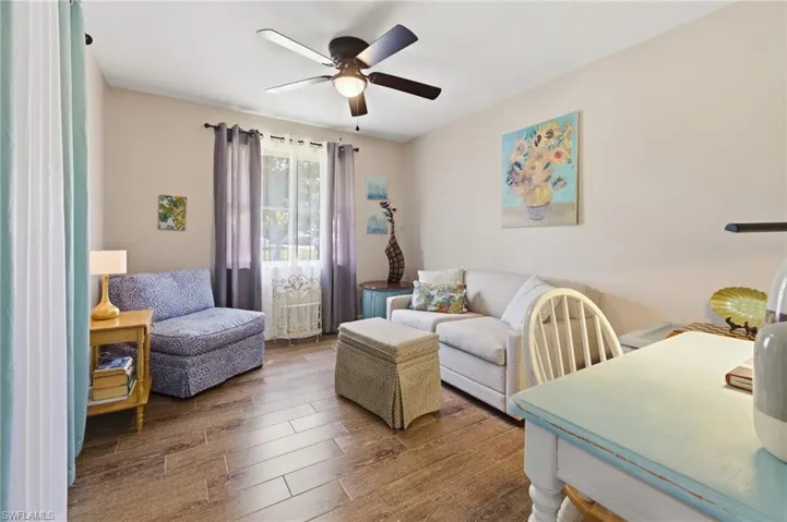 Bedroom, being used as a Den  featuring wood-style tile floors and a ceiling fan