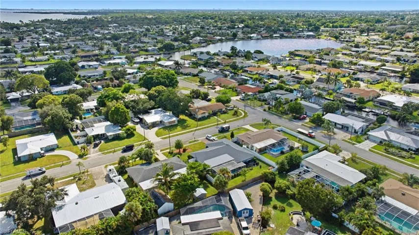 Aerial overview of property's location with a nearby body of water and nearby suburban area