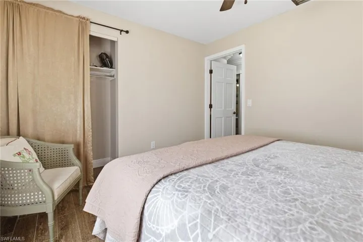Bedroom featuring wood tile floors, a closet, and ceiling fan