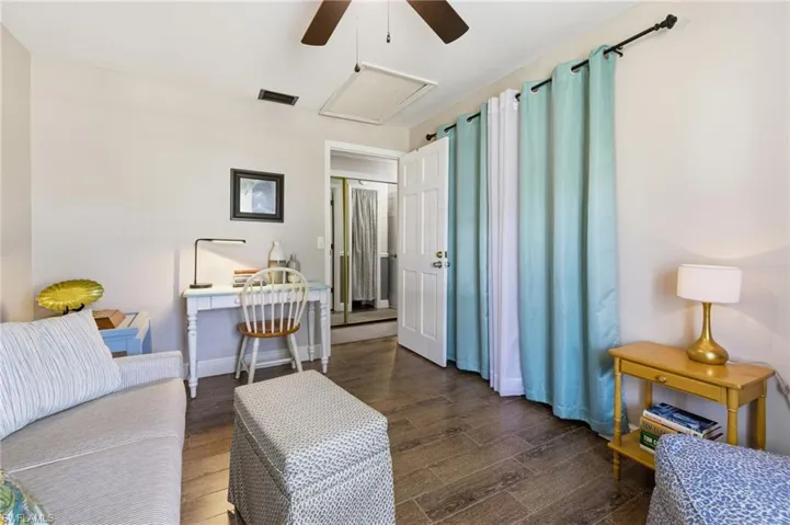 Bedroom, being used as a Den  featuring wood-style tile floors and a ceiling fan