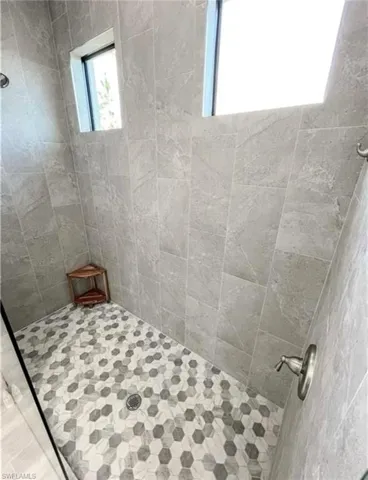Full bathroom featuring tiled shower