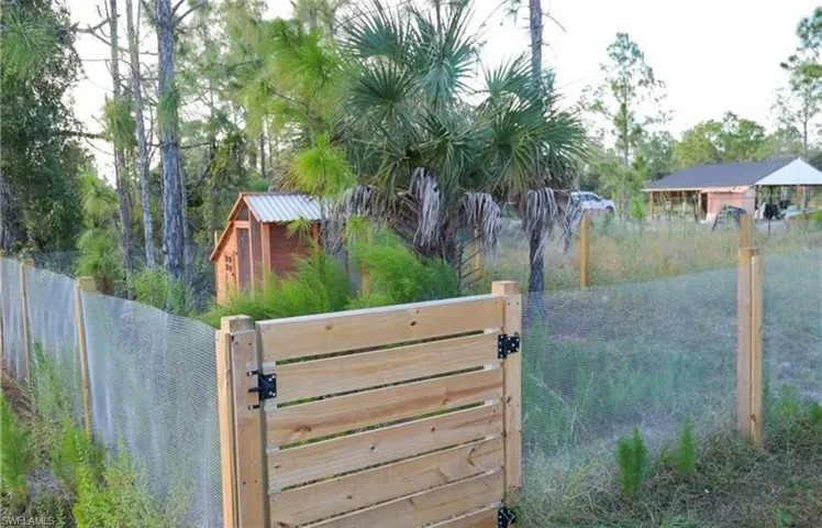 View of gate featuring fence