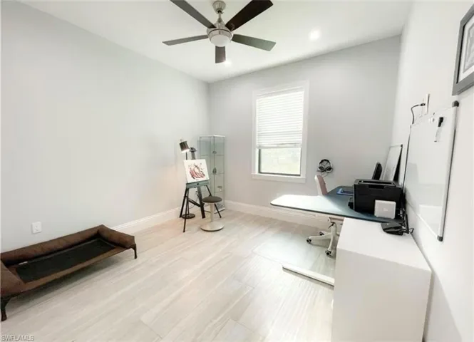 Office space with recessed lighting, baseboards, a ceiling fan, and light wood finished floors