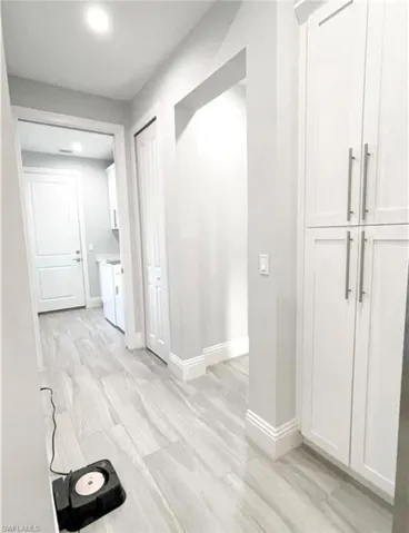 Hallway with light wood finished floors and baseboards