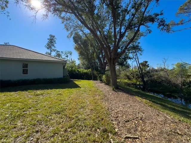 Side yard back to preserved space lends to the privacy and tranquility you will feel when you step foot into your dream home in Naples!