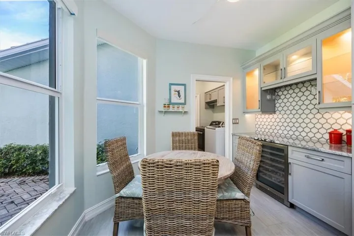 Darling kitchen breakfast dining with bright light from windows facing preserve and side yard all within reach of the wine fridge and coffee station.