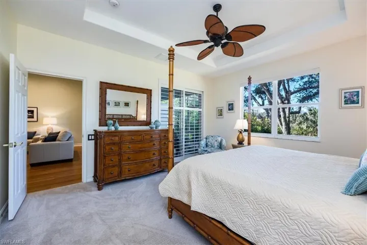 Master bedroom with new light neutral carpet and views of private tropical preserve.