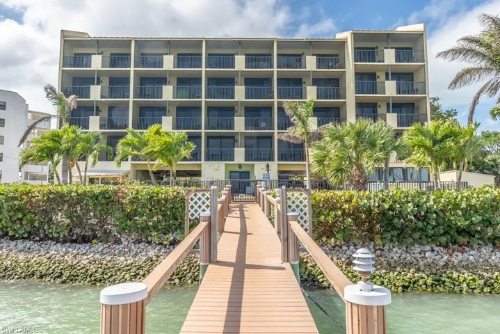 Dock area featuring a balcony and a water view