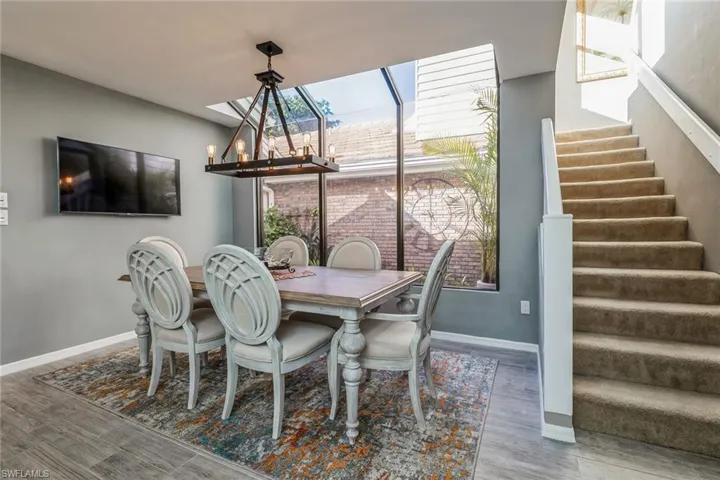 Dining Area with view of Atrium and stairs to 2nd Bedroom Suite and Loft/Den