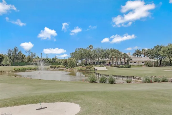 View of community featuring view of golf course, a lawn, and a water view