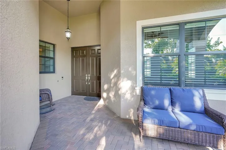 Entrance to property with a patio and stucco siding