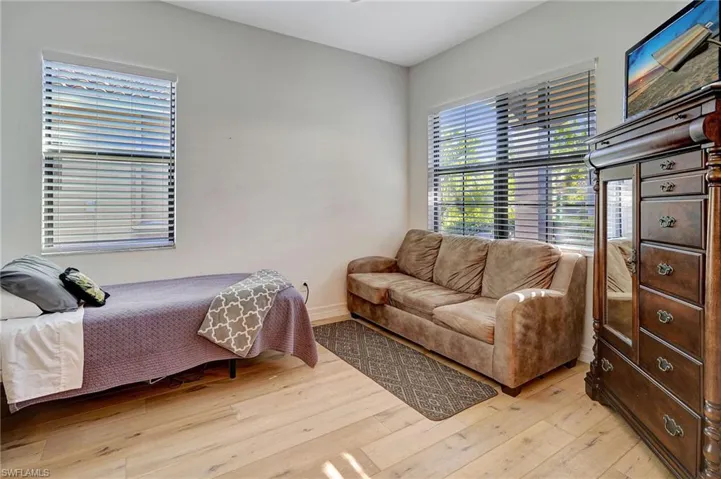 Bedroom with wood-type flooring and baseboards