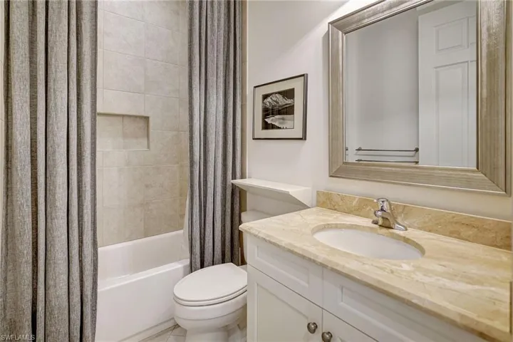 Full bath featuring toilet, shower / bath combo, and vanity