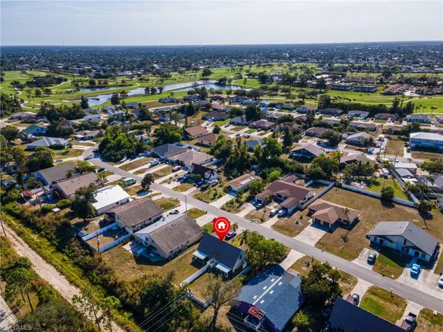 Aerial perspective of suburban area featuring a nearby body of water