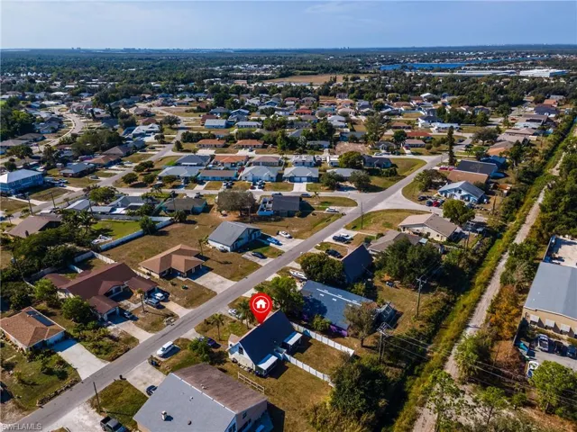 Aerial view of property's location featuring nearby suburban area