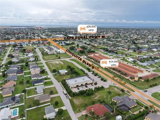 Aerial view of property's location with nearby suburban area