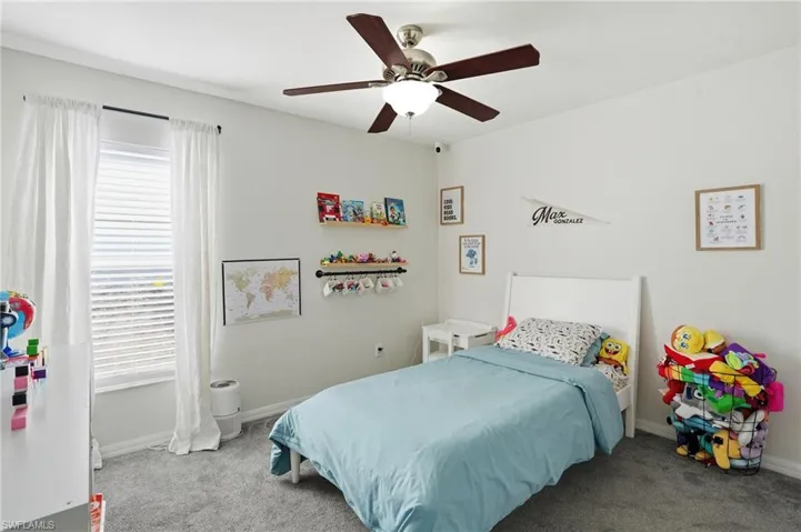 Bedroom with carpet flooring and a ceiling fan
