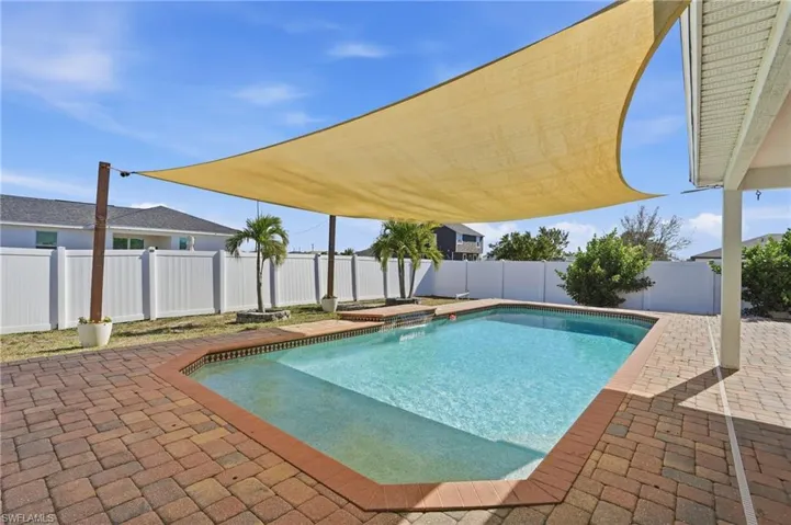 View of pool with a fenced backyard and a patio