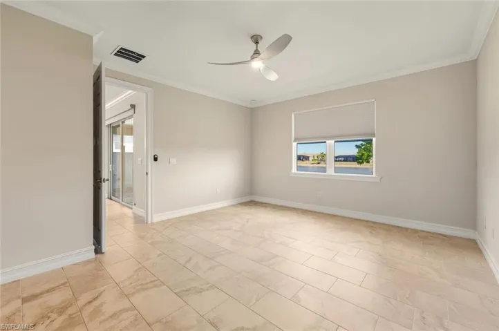 Spare room featuring crown molding and ceiling fan