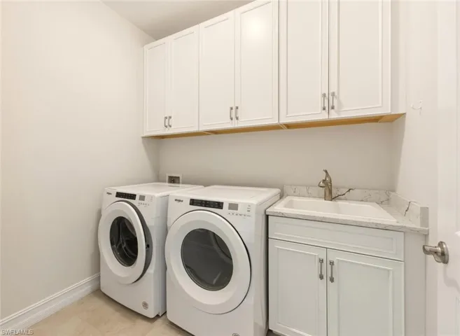 Laundry room with independent washer and dryer and cabinet space