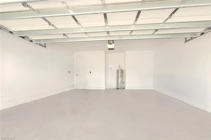 Garage featuring electric water heater