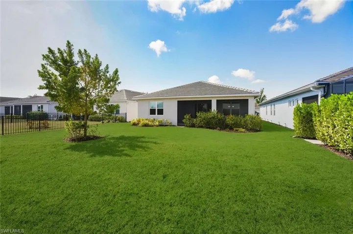 Rear view of property with stucco siding and a sunroom