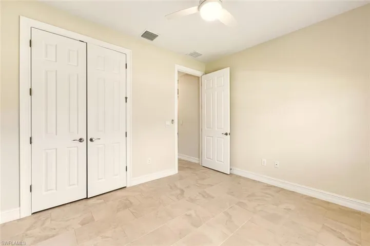 Unfurnished bedroom featuring a ceiling fan and a closet