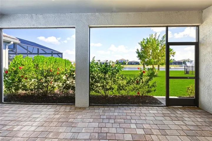 Unfurnished sunroom with a water view and a residential view