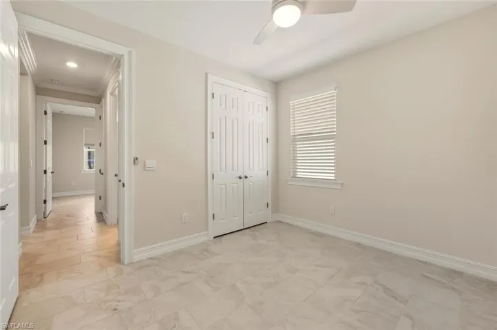 Unfurnished bedroom with ceiling fan, a closet, ornamental molding, and recessed lighting