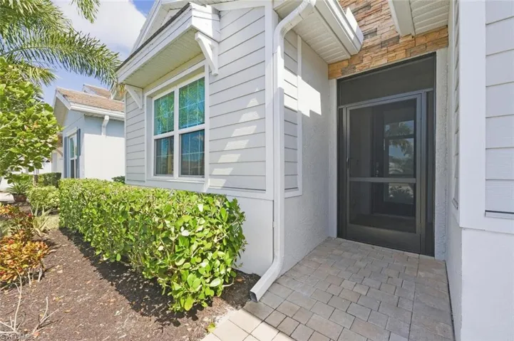 Doorway to property featuring stone siding