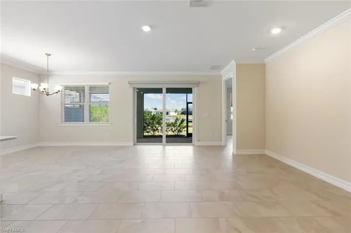 Empty room with a chandelier and crown molding