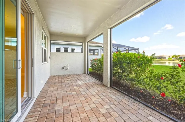View of patio with a sunroom, a lanai, and a water view