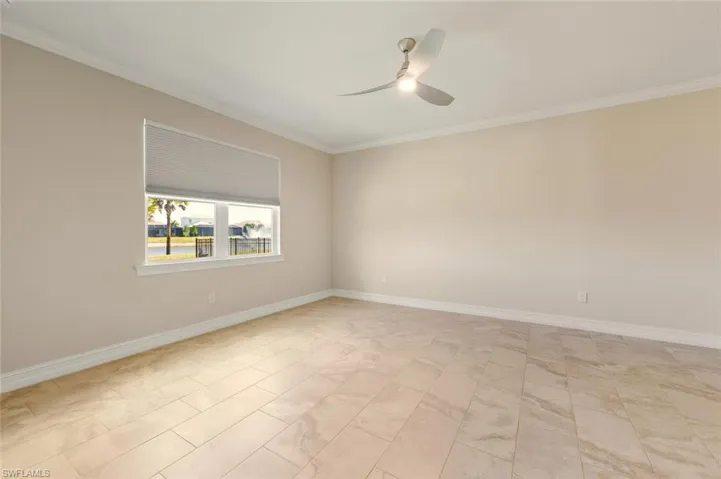 Empty room with ornamental molding and ceiling fan