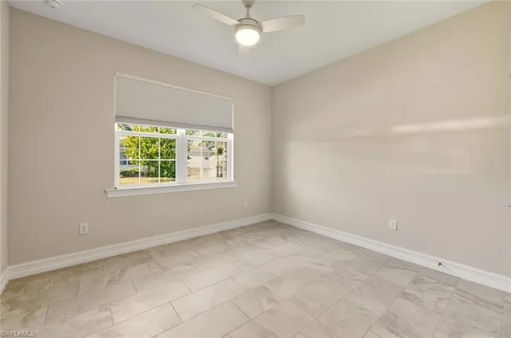 Spare room featuring baseboards and a ceiling fan